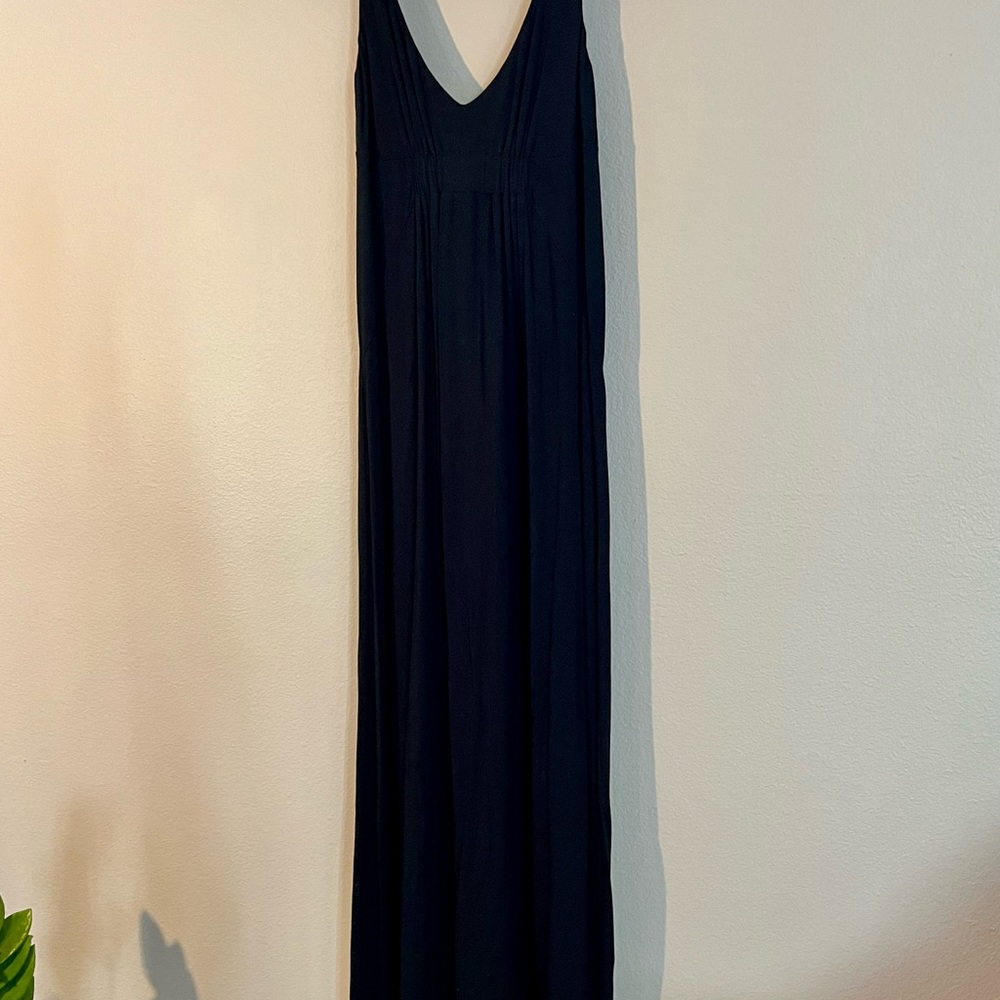 Long black flowing maxi dress with ruched detail and empire waist.